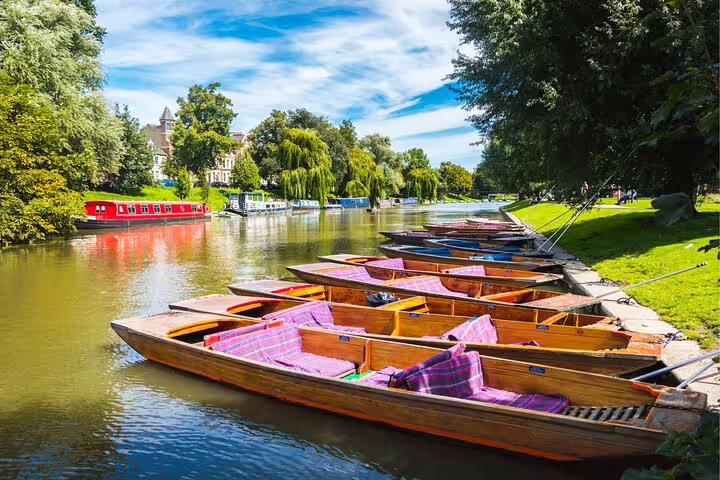 Punts moored on the River Cam in Cambridge, ideal scene for a self-guided scavenger hunt highlights tour