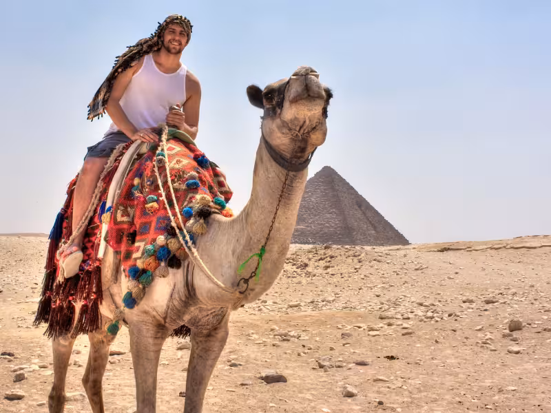 Camel ride at Giza with the Great Pyramid in the background, classic Wonders of the Pharaohs desert experience