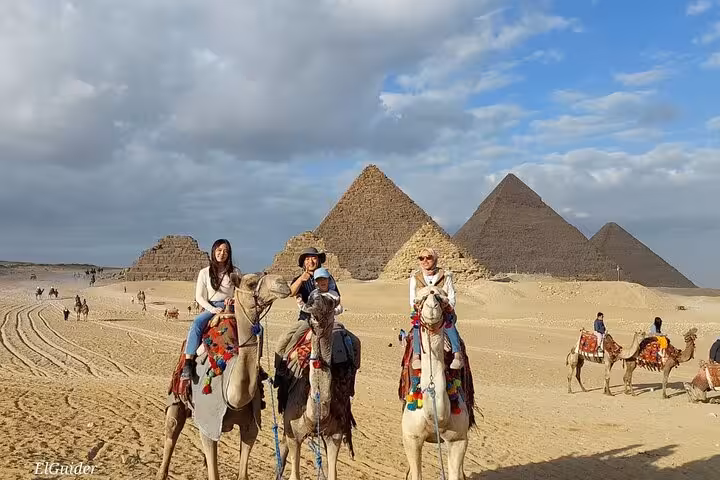 Camel ride at Giza Pyramids on private tour from Cairo Airport, desert view with pyramids backdrop