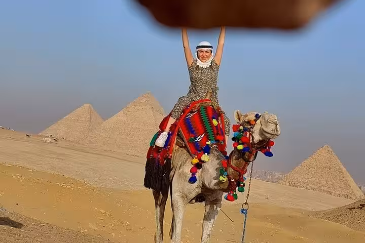 Camel ride at Giza Plateau with pyramids in the background, classic photo stop on a private Cairo day tour