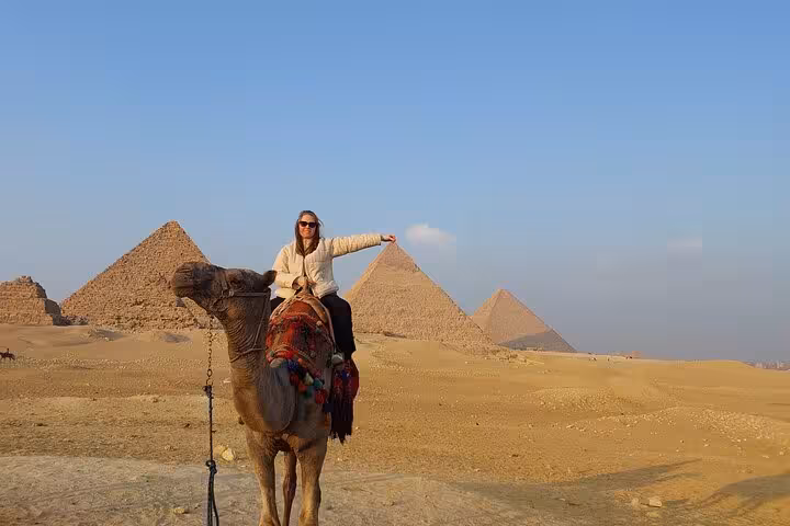 Camel ride at Giza Pyramids on private Cairo Airport tour to pyramids and Egyptian Museum