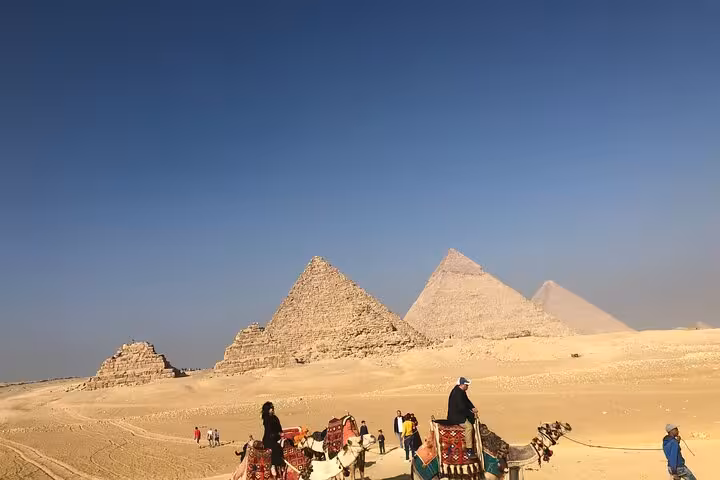 Camel ride experience in the Giza desert with panoramic view of the pyramids on a private full-day Cairo tour