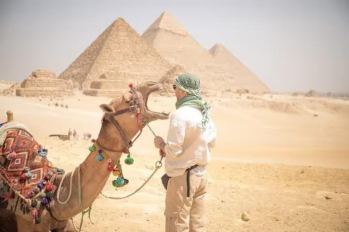 Camel ride view at Giza Pyramids desert on private Cairo tour, iconic photo stop near the Great Pyramids