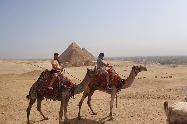 Camel ride at the Giza Pyramids desert viewpoint on a private full-day tour to Giza and Saqqara, Cairo