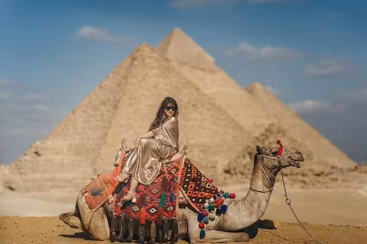 Camel ride photo stop at Giza Pyramids, Egypt, on private tour including Sphinx, Grand Egyptian Museum and bazaar