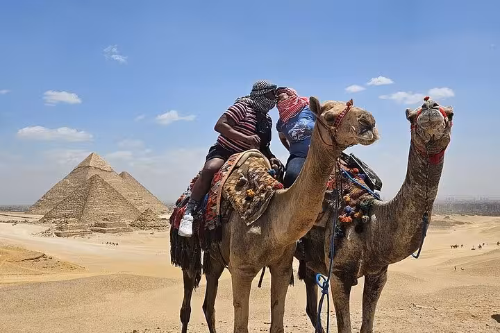 Camel ride in the Giza desert with pyramids in the background, private Pyramids Giza and Sphinx tour Cairo