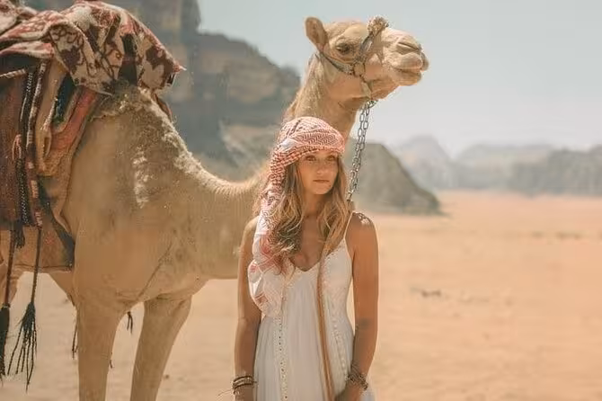 Camel and traveler in Egypt desert, a highlight of the 2-day Bahariya Oasis camp tour from Cairo