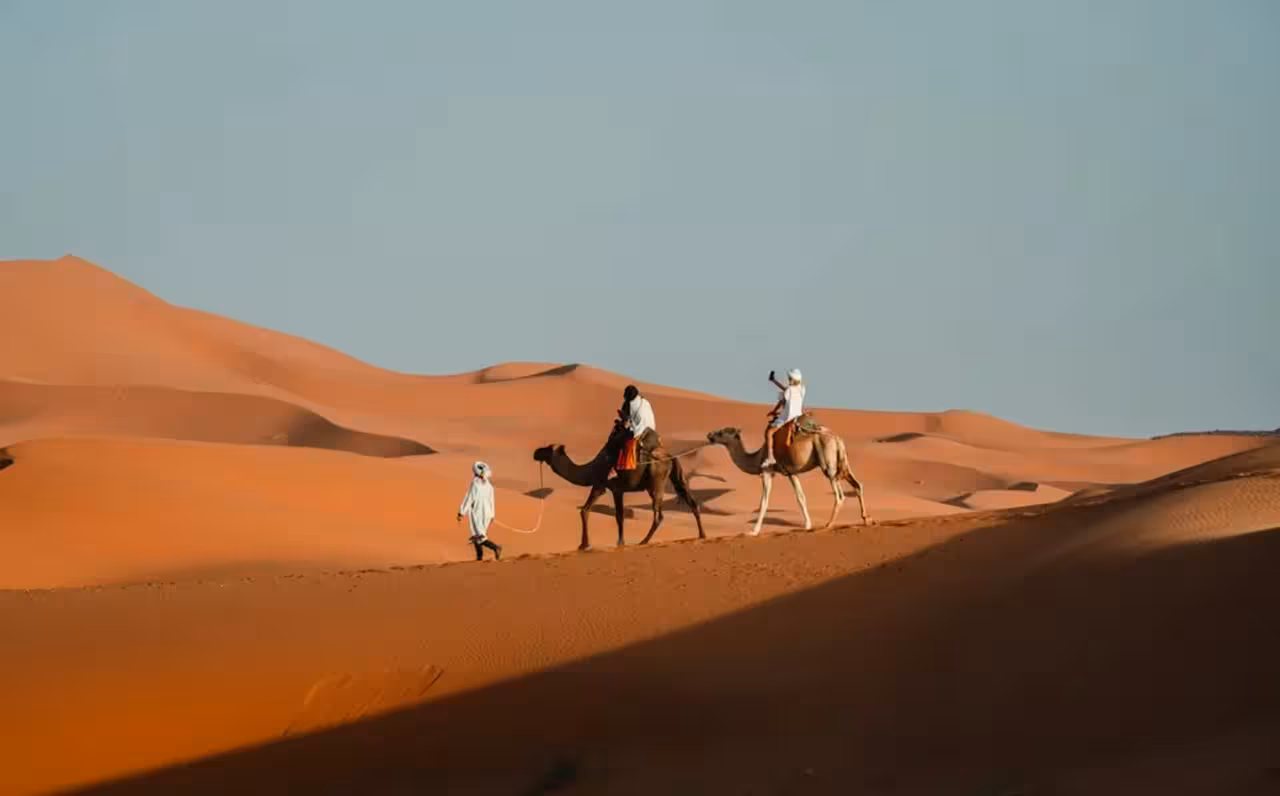Experience camel trekking across Merzouga's golden dunes on a 4-day desert tour from Marrakech to Fez.