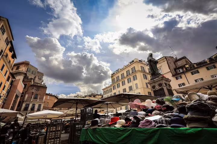 Colorful hat stalls at Campo de’ Fiori market in Rome, visited on a private one day city tour with hotel pick-up