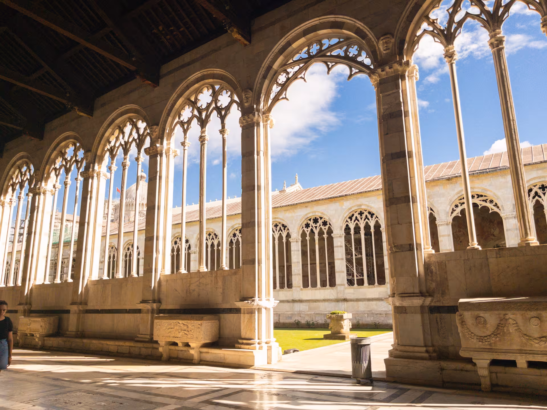 Elegant arches of the Camposanto Monumentale in Pisa on a sunny day during a Florence to Pisa tour.