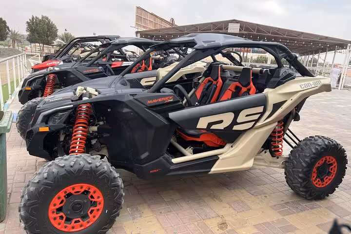 Can-Am Maverick RS dune buggy parked at desert base, premium off-road quad bike style desert safari ride