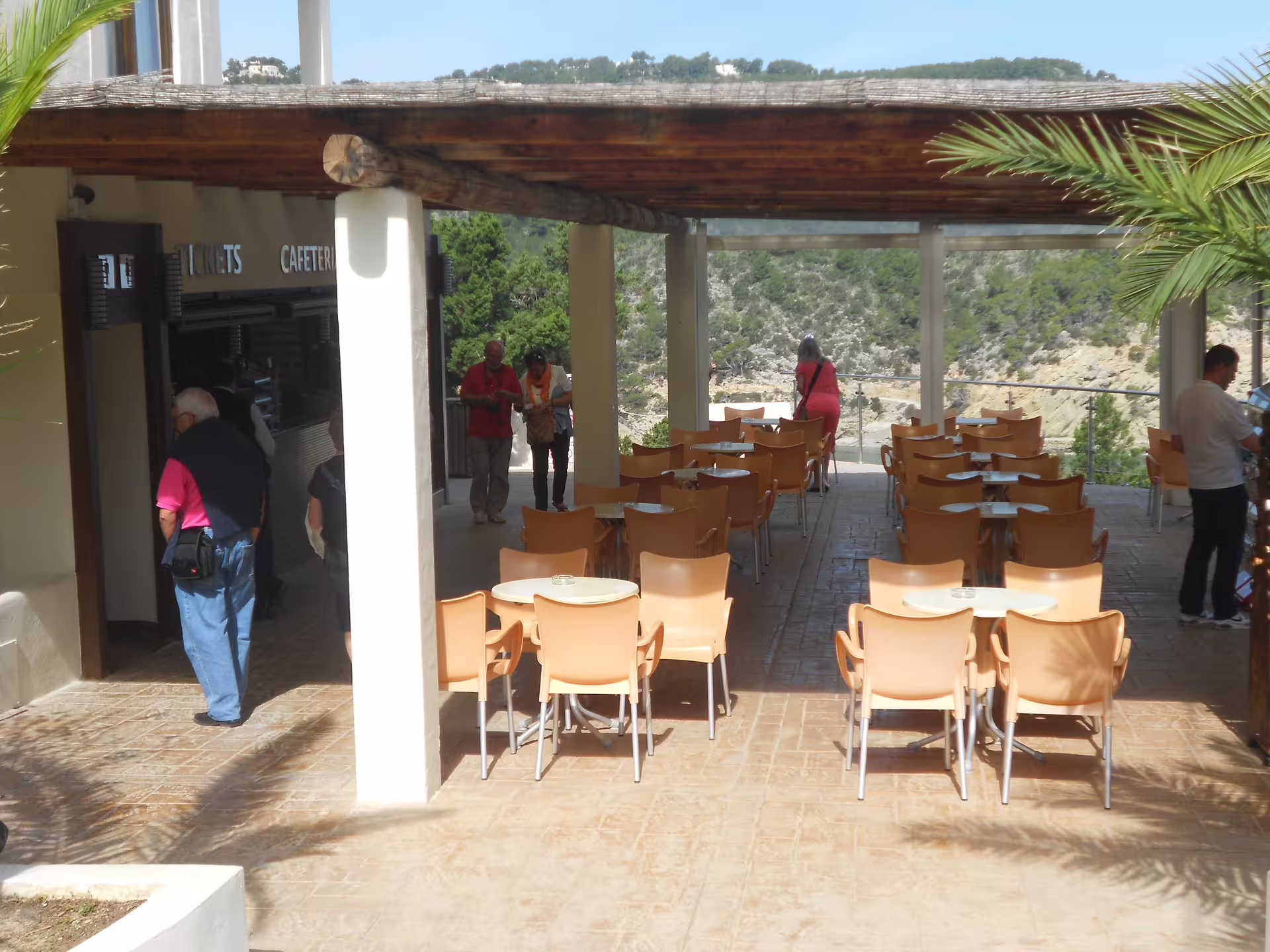 Can Marçá Cave entrance terrace with ticket office and café seating in Puerto de San Miguel, Ibiza tour meeting point