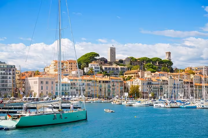 Scenic view of Cannes harbor with yachts and historic architecture, ideal for a picturesque private tour.