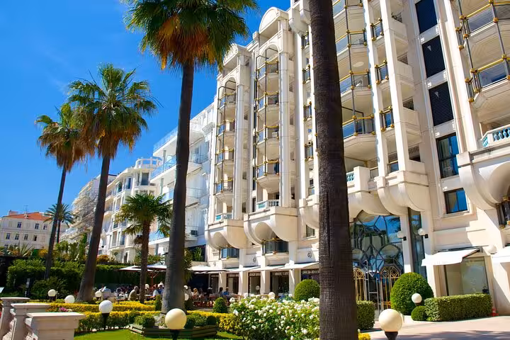 Luxurious Cannes hotel with palm trees, part of the Wine Tasting and Coco Chanel tour in the French Riviera.