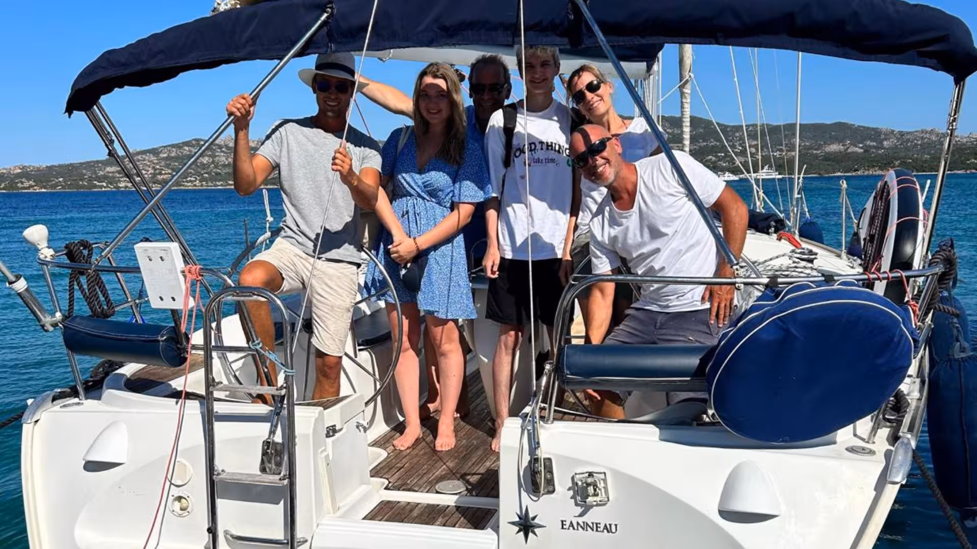Group enjoying a sunny day on a sailboat in La Maddalena Archipelago, highlighting the joy of a Cannigione sailing tour.