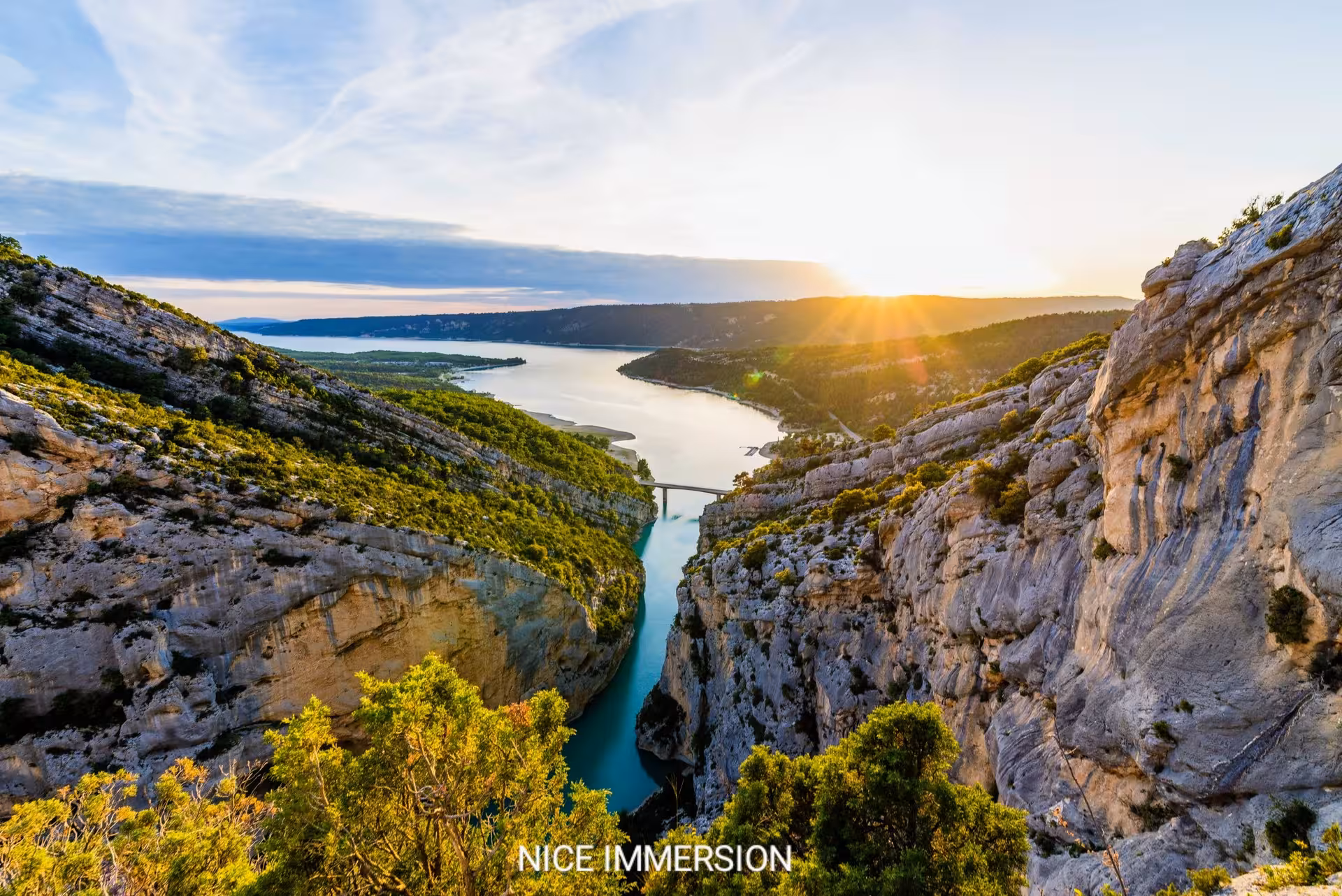 Discover breathtaking views of the Canyon of Verdon at sunset, featuring dramatic cliffs and serene waters.