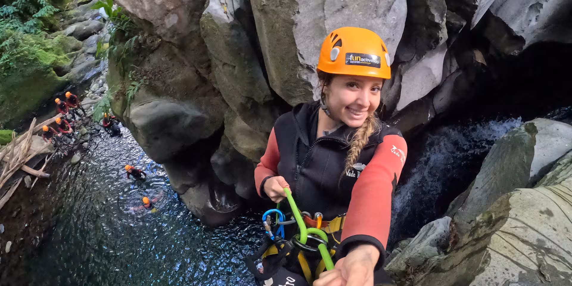 Canyoning rappel at Salto do Cabrito, São Miguel Azores, with guide rope above a waterfall and pool