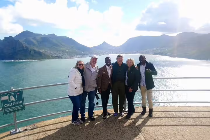 Group of tourists enjoying scenic views at Cape of Good Hope during a small group tour from Cape Town.