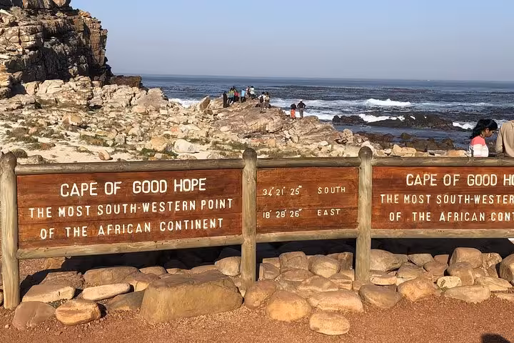Cape of Good Hope sign at rocky shoreline, highlighting the southernmost point on the African continent.