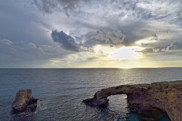 Cape Greco sea cave arch at sunset, scenic stop on half-day Ayia Napa and Cape Greco tour from Larnaca