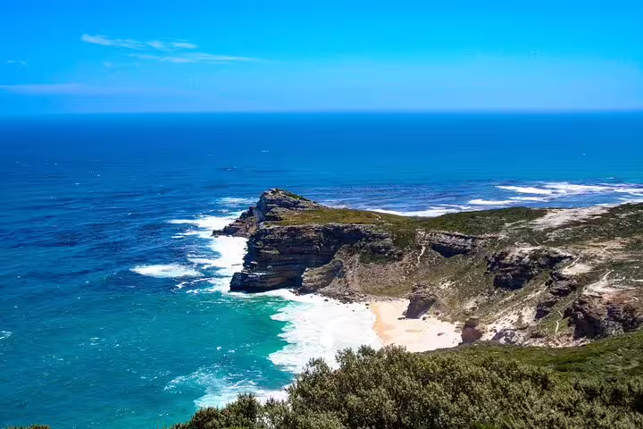 Stunning view of Cape of Good Hope with turquoise waters and rugged cliffs on a clear day.