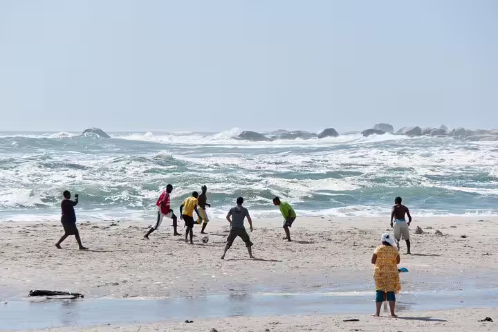 Beach soccer on Cape Peninsula coastline with crashing Atlantic surf, featured on Cape Town full-day trip