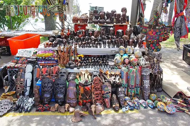 Vibrant African crafts and souvenirs displayed at a local market on the Cape Point day tour.