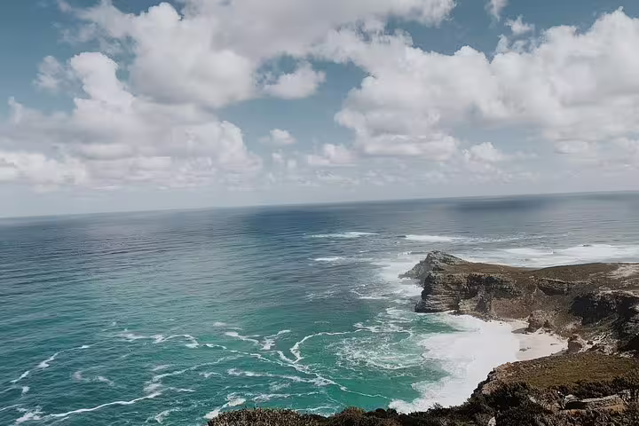 Breathtaking view of Cape Point's rugged coastline and azure waters, a highlight of Cape Town's natural wonders.