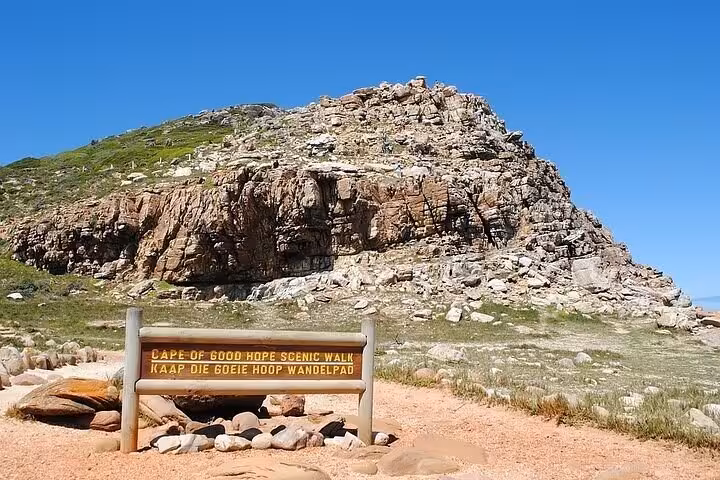 Cape of Good Hope scenic walk signpost against a rocky hill under a clear blue sky, perfect for Cape Point tours.