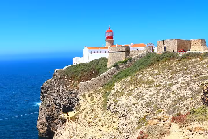 Picturesque Cape St. Vincent lighthouse perched on dramatic cliffs, a highlight of Algarve private tours.