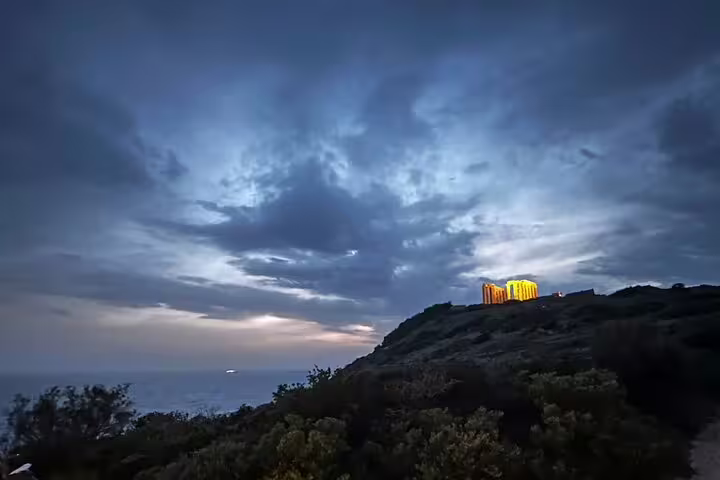 Temple of Poseidon glowing at dusk on Cape Sounio private tour, Athenian Riviera sunset over the Aegean Sea