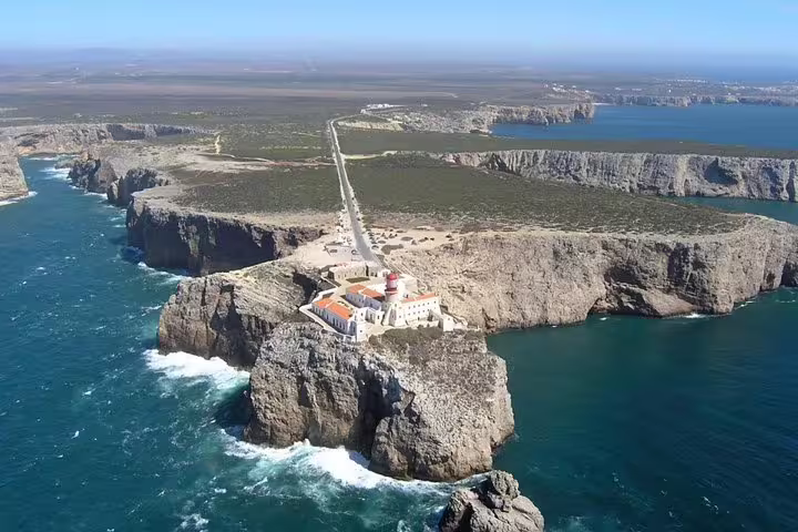 Aerial view of Cape St. Vincent lighthouse on the dramatic cliffs of Sagres, Portugal, featured in Algarve tour from Lisbon.