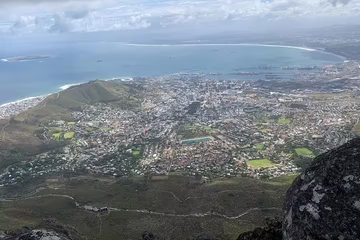 Aerial view of Cape Town with sweeping vistas of the city, coastline, and Table Bay, highlighting South Africa's scenic beauty.