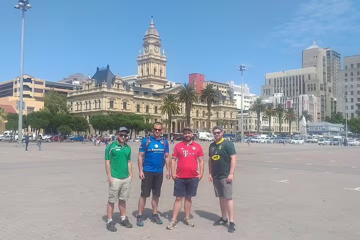 Tourists stand in front of the historic Cape Town City Hall, a highlight of the Cape Town City Half Day Tour.
