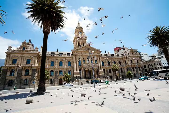 Historic Cape Town City Hall with palm trees and pigeons, a highlight of the Cape Town City and Table Mountain tour.