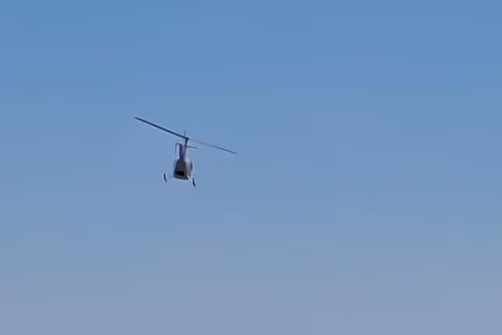 Helicopter in flight over Cape Town, showcasing views from the Atlantic Coast to Hout Bay.