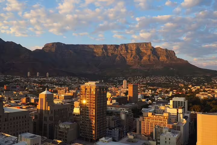 Cape Town city skyline at sunset with Table Mountain backdrop, highlight on Cape Peninsula full-day trip