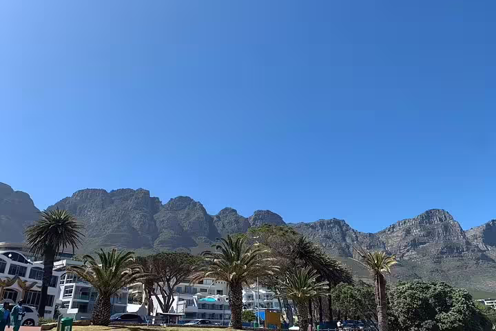 Stunning view of Cape Town's iconic Twelve Apostles mountain range under a clear blue sky.