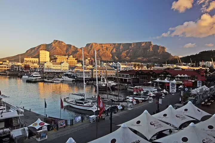 V&A Waterfront marina with Table Mountain backdrop on a full-day Cape Town sightseeing tour at sunset
