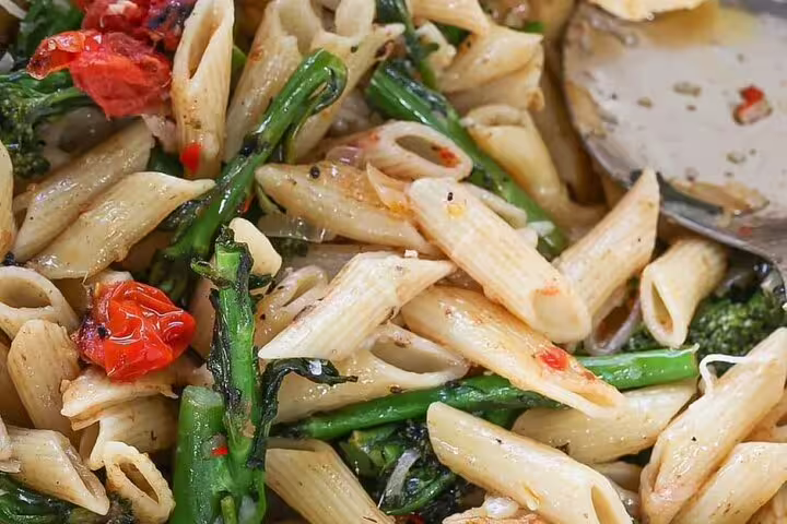 Close-up of a delicious pasta dish with vegetables, showcasing local culinary delights on the Cape Town walking tour.