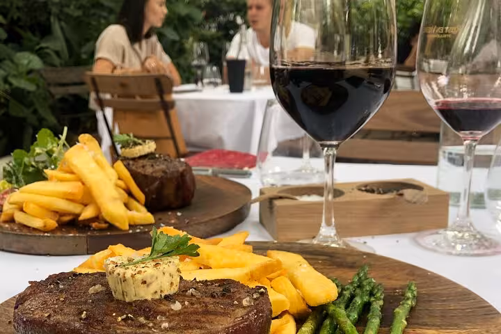 Gourmet meal with steak, fries, and wine pairing in Cape Winelands, perfect for a full day tasting tour.