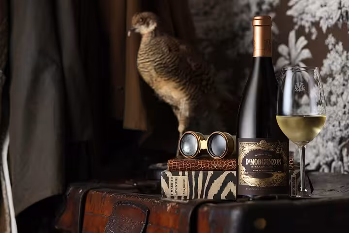 Elegant wine bottle and glass on display in Cape Winelands tour, showcasing Stellenbosch's wine heritage.