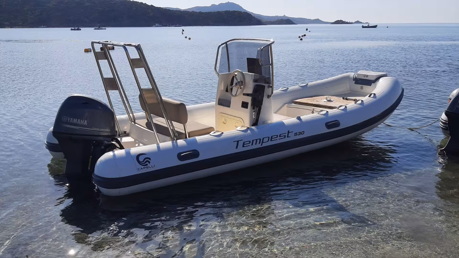 A sleek Capelli Tempest 530 dinghy moored in Chia, ready for a thrilling 4-hour coastal exploration tour.