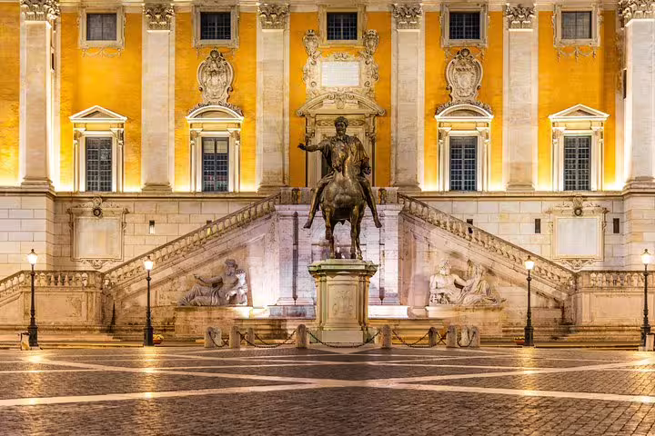 Illuminated Capitoline Hill square in Rome with equestrian statue and grand staircase on private Capitoline Museums tour