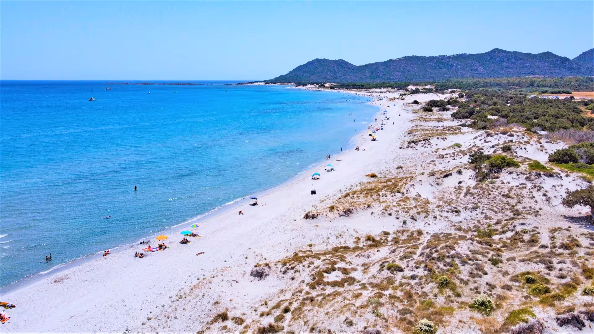 Stunning view of Capo Comino beach with turquoise waters and white sand on the Orosei jeep tour.
