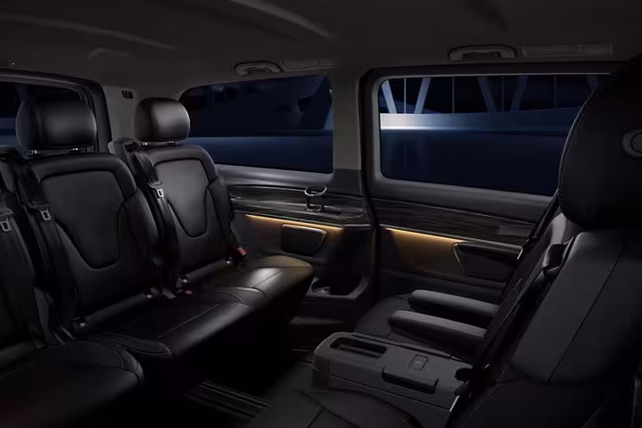 Premium black leather cabin inside private Cappadocia airport transfer vehicle, spacious seating and ambient lights