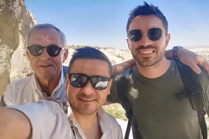 Friends selfie at Cappadocia viewpoint on business class plane tour, enjoying scenic fairy chimneys