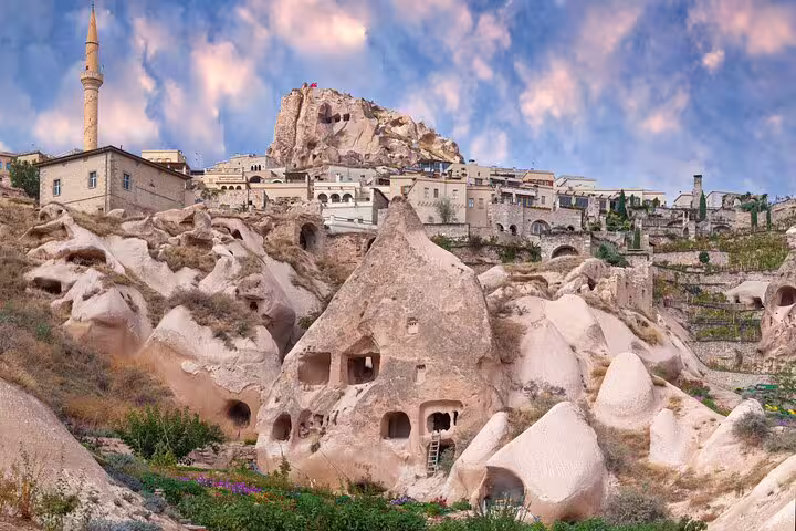 Charming cave dwellings and historic architecture under a vibrant sky in Cappadocia, ideal for private tours.