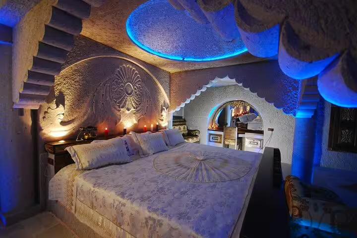 Cappadocia cave hotel bedroom with carved stone arches, ideal 4-star stay on Turkey 13-day guided tour