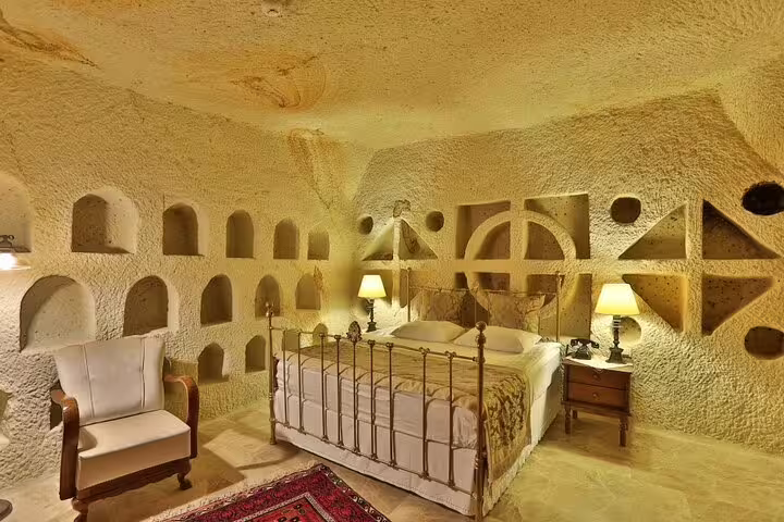 Traditional Cappadocia cave hotel room interior in Göreme, cozy overnight stay on Istanbul to Cappadocia tour